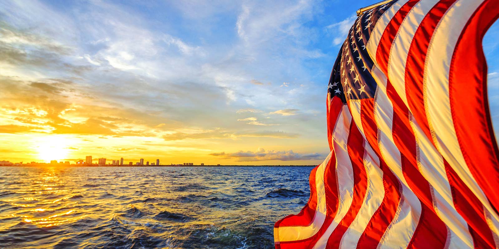 american flag near the ocean